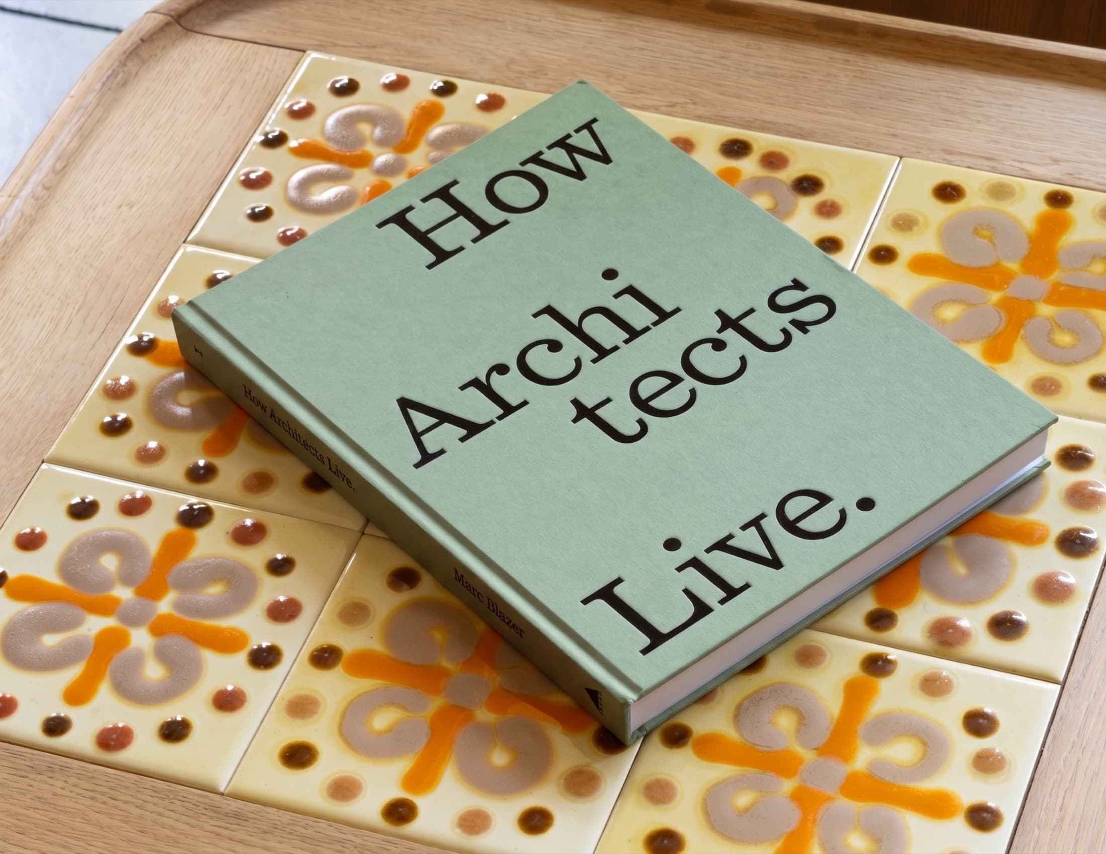 The book resting on a tray of hand-painted tiles.